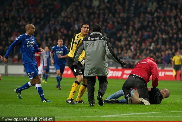  (L-R) Simon Poulsen of AZ and goalkeeper Esteban Alvarado Brown of AZ and stewards react following an attack on Brown by a supporter during the Dutch cup match between Ajax and AZ Alkmaar at the Amsterdam Arena on December 22, 2011 in Amsterdam, Netherlands.