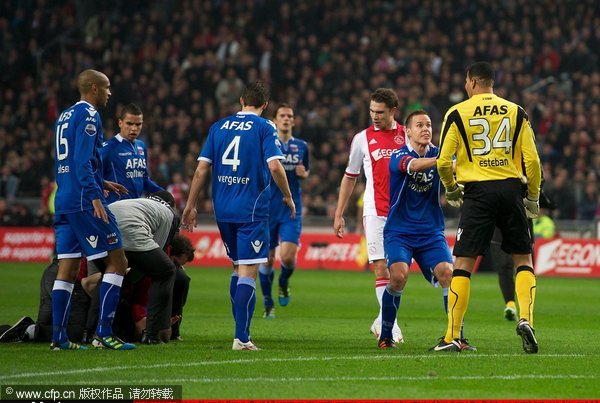 Goalkeeper Esteban Alvarado Brown (R) of AZ reacts as stewards restrain a supporter who attacked him during the Dutch cup match between Ajax and AZ Alkmaar at the Amsterdam Arena on December 22, 2011 in Amsterdam, Netherlands.