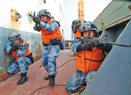 Soldiers are put through their paces on a merchant vessel before an escort mission in the Gulf of Aden earlier this year. [Chen Zhiyuan/China Daily]