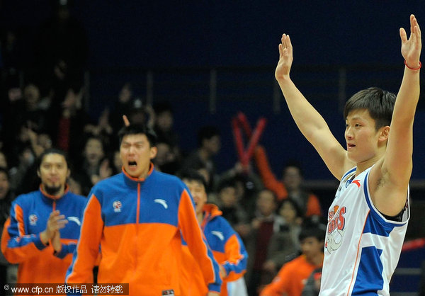 Players of Shanghai Sharks celebrate victory in a CBA game between Shanghai and Beijing on Dec. 25, 2011.