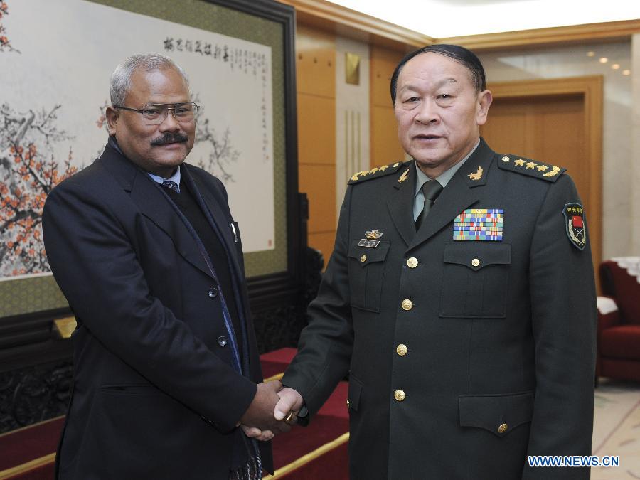 Chinese Defense Minister Liang Guanglie (R) shakes hands with Nepali Deputy Prime Minister Bijay Kumar Gachchadar in Beijing, capital of China, Dec. 26, 2011. [Xie Huanchi/Xinhua]
