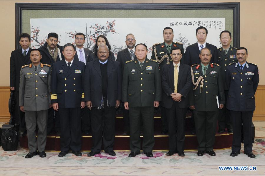 Chinese Defense Minister Liang Guanglie (C, Front) and Nepali Deputy Prime Minister Bijay Kumar Gachchadar (3rd L, Front) pose for group photo in Beijing, capital of China, Dec. 26, 2011. [Xie Huanchi/Xinhua]