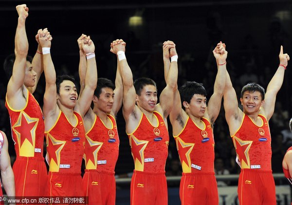 Chinese gymnasts celebrate on the podium after winning the gold medal in the men's team final at the Artistic Gymnastics World Championships in Tokyo, Japan, 12 October 2011. China won the competition followed by Japan with silver and United States with bronze. 