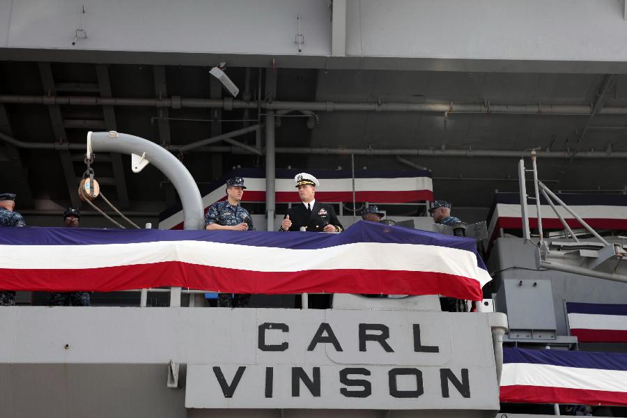 US Navy servicemen chat on the aircraft carrier USS Carl Vinson in Hong Kong, south China, Dec. 27, 2011. The nuclear-powered supercarrier berthed in the water area of Hong Kong on Tuesday, starting a three-day visit for replenishment. [Jin Yi/Xinhua] 