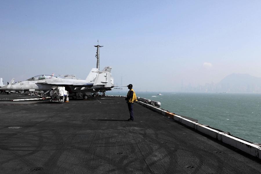 A US Navy serviceman stands on the flight deck of the American aircraft carrier USS Carl Vinson in Hong Kong, south China, Dec. 27, 2011. The nuclear-powered supercarrier berthed in the water area of Hong Kong on Tuesday, starting a three-day visit for replenishment. [Jin Yi/Xinhua] 
