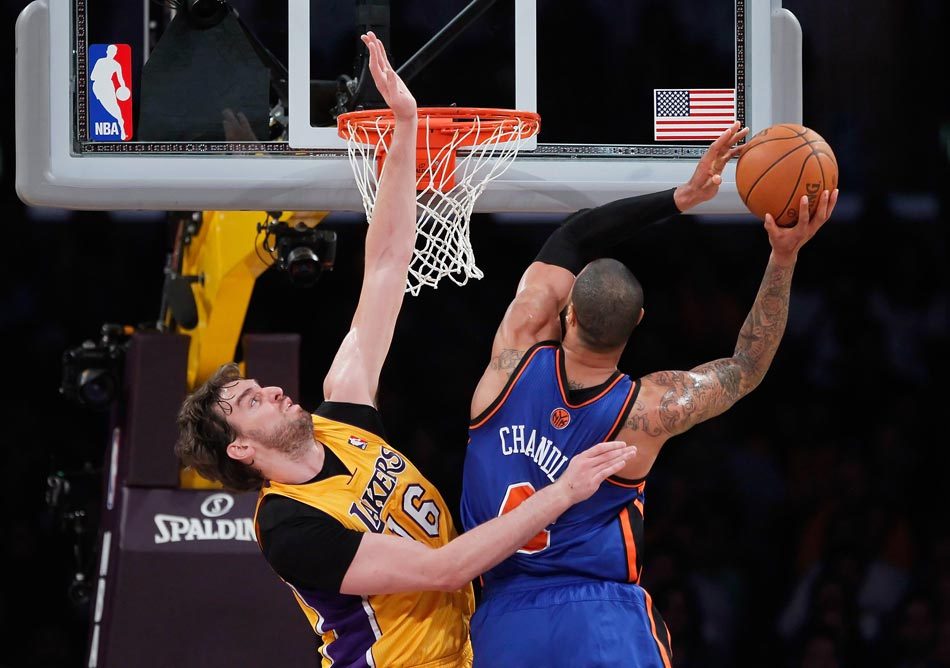 Pau Gasol of the Los Angeles Lakers defends Tyson Chandler of the New York Knicks in the first half at Staples Center on December 29, 2011 in Los Angeles, California.