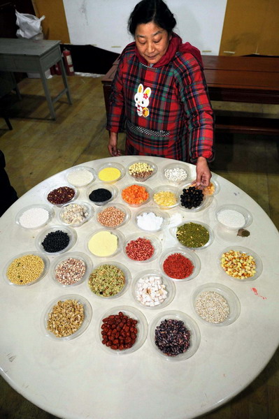 A woman prepares Laba rice porridge for the Laba Festival celebrations in Nanjing, Dec 31, 2011. 