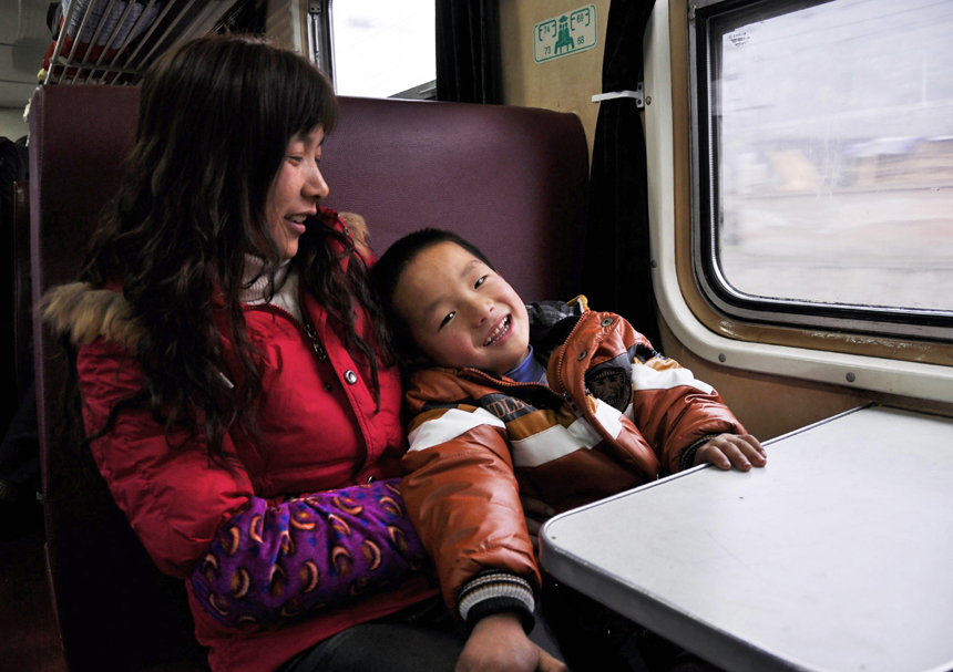 Spring Festival, or Chinese Lunar New Year, which this year falls on Jan. 23, is traditionally the time when millions of Chinese rush home for family reunions and celebrations. Here, mother and son are happy to be finally underway in Nanjing, Jiangsu Province, on Jan. 3. [Xinhua photo]