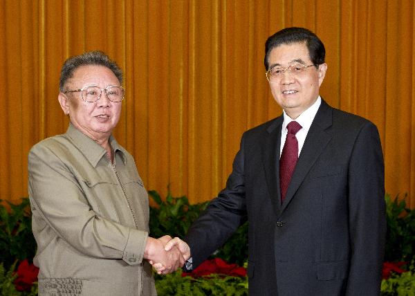 Chinese President Hu Jintao (R) shakes hands with North Korean leader Kim Jong Il at a meeting in Beijing on May 25, 2011. [Li Xueren/Xinhua]