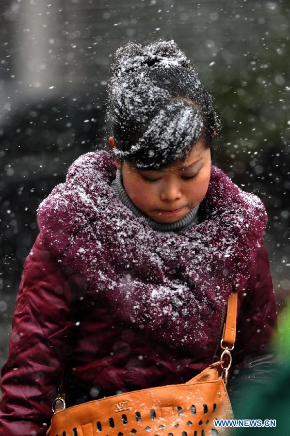 A pedestrian walks in snow in Guiyang, capital of southwest China's Guizhou Province, Jan. 4, 2012.