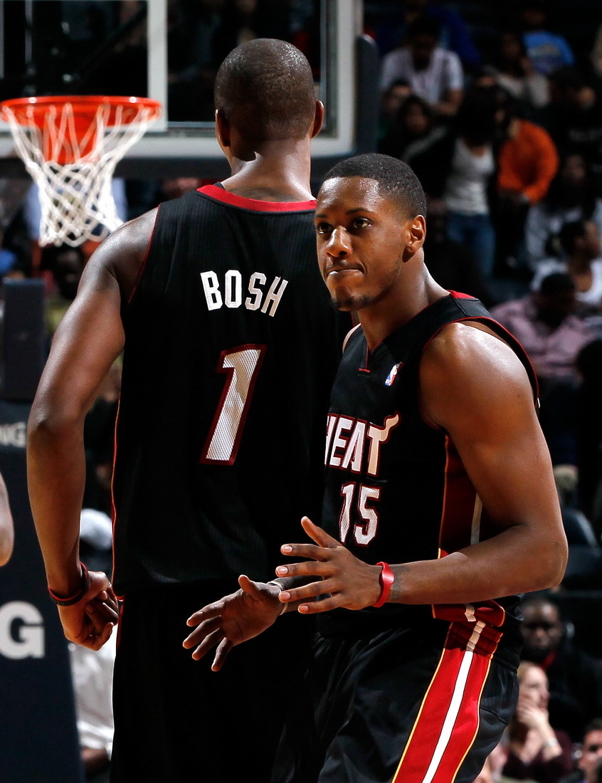 Mario Chalmers and Chris Bosh of the Miami Heat react after a basket against the Atlanta Hawks at Philips Arena on January 5, 2012 in Atlanta, Georgia.