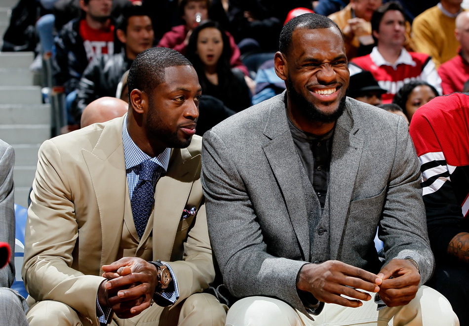  Injured Miami Heat stars Dwyane Wade and LeBron James react as a teammate scores in the second quarter of an NBA basketball game against the Atlanta Hawks in Atlanta on Thursday, Jan. 5, 2012.