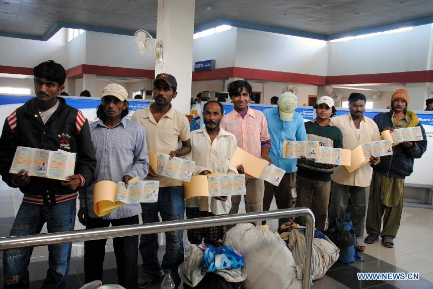 Released Indian fishermen stand in a queue for immigration clearance at Wagah Border in eastern Pakistan's Lahore, on Jan. 8, 2012. Pakistan released nearly 179 Indian fishermen and another Indian citizen on Saturday from a prison in the southern port city of Karachi, a state-run television reported on Saturday.