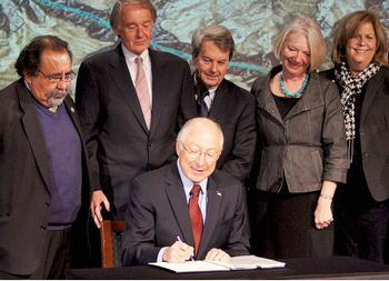 Secretary of Interior Ken Salazar signs the Record of Decision withdrawing one million acres from mining consideration, January 9, 2012. [Navajo Nation Washington Office]