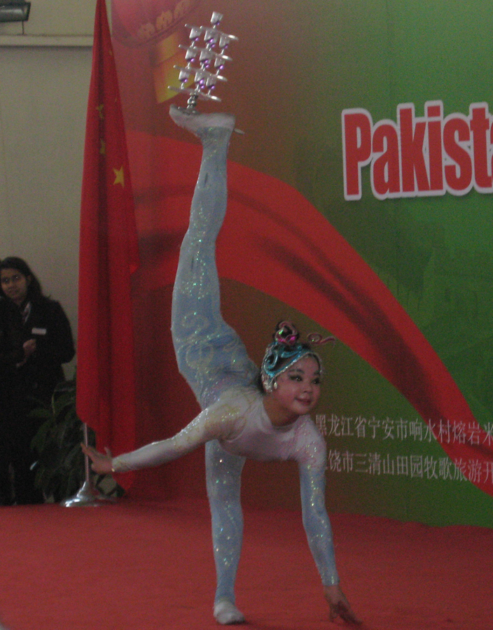 A girl performs acrobatics during a cultural show which is held to celebrate the 60th anniversary of the establishment of diplomatic relations between China and Pakistan in Beijing, Jan. 11, 2011. [Zhang Ming'ai/China.org.cn]