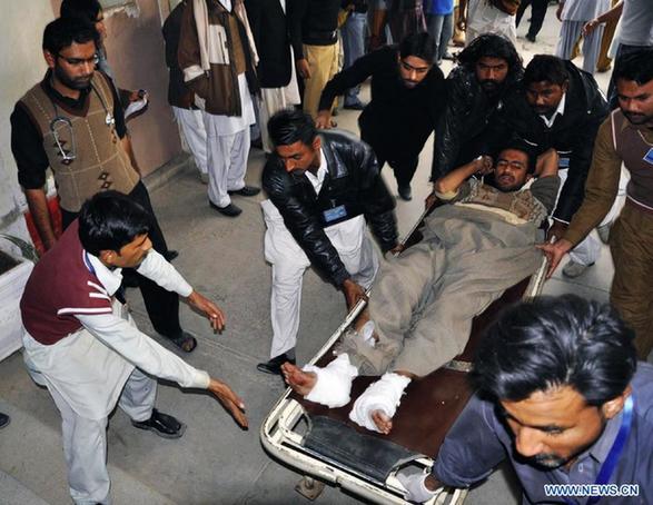 People transfer an injured man from the blast site in eastern Pakistan's Khanpur on Jan. 15, 2012. At least 18 people were killed and over 30 injured when a bomb blast hit a religious procession in eastern Pakistani province of Punjab on Sunday, reported local Urdu TV ARY. [Faisal Sheikh/Xinhua] 