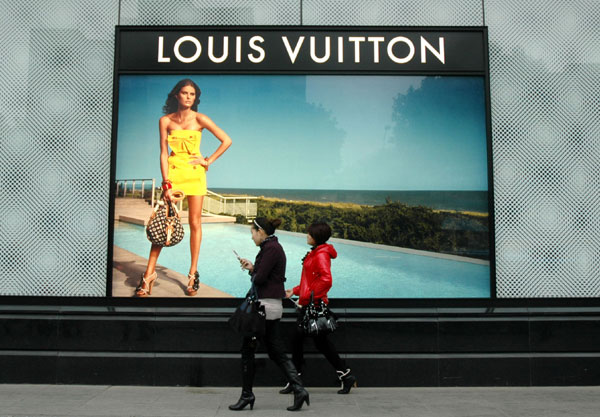 Large advertisements for luxury brands, such as this one for Louis Vuitton in downtown Wuxi, Jiangsu province, are now common in cities, big and small, across China. [China Daily]
