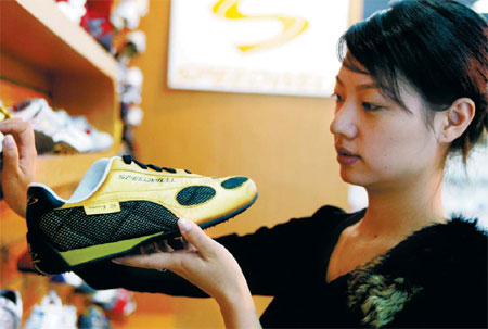 A visitor at a shoe exhibition in Beijing. Chinese enterprises, led by shoemakers in Wenzhou in Zhejiang province, are shifting their focus to domestic sales as external demand drops.[China Daily]