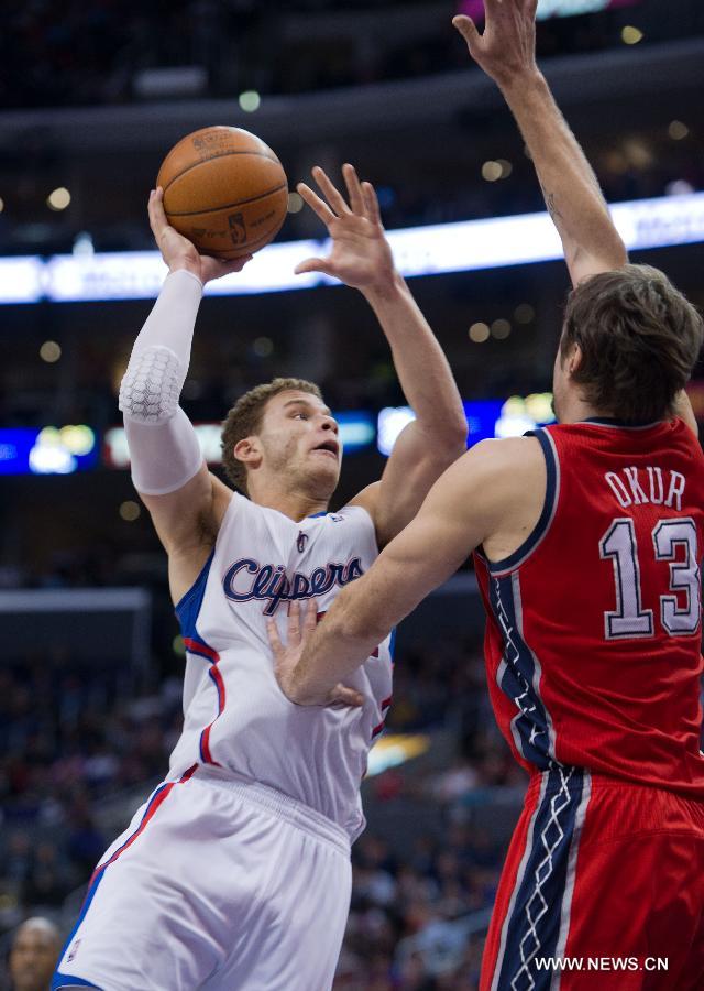 Blake Griffin(L) of Los Angeles Clippers shoots a ball during a NBA game against New Jersey Nets at Staples Center in Los Angeles on Jan. 16, 2012. Los Angeles Clippers beat New Jersey Nets 101-91.(Xinhua/Yang Lei) 