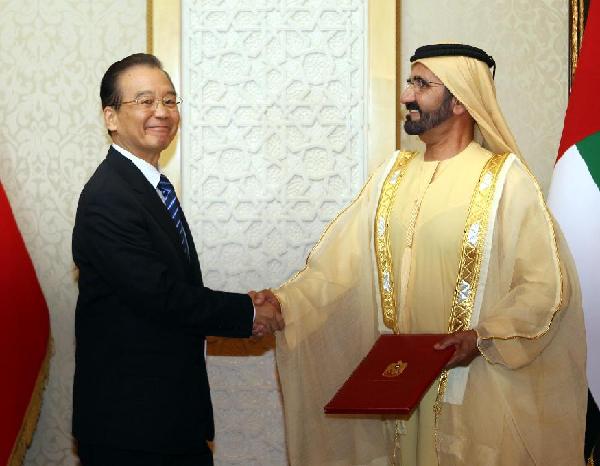 Chinese Premier Wen Jiabao (L) shakes hand with Sheikh Mohammed bin Rashid Al Maktoum, Vice President and Prime Minister and Ruler of Dubai of the United Arab Emirates after signing documents about bilateral cooperation in Dubai, the United Arab Emirates, Jan. 17, 2012. [Liu Weibing/Xinhua] 