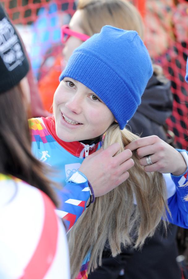 Clara Direz of France fixes up her hair after competing of the women's alpine skiing giant slalom race at the first Winter Youth Olympic Games in Innsbruck, Austria, Jan. 18, 2012. Clara Direz claimed the title of the event with a time of 1:56.13. [Xinhua photo]