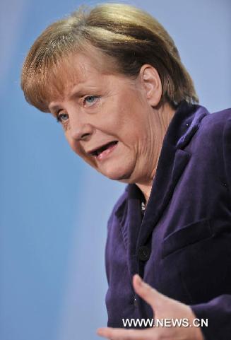 German Chancellor Angela Merkel attends a press conference after meeting with French President Nicolas Sarkozy in Berlin, capital of Germany, Jan. 9, 2012. [Ma Ning/Xinhua]
