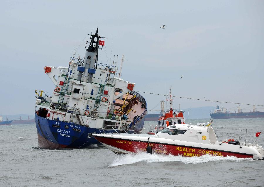 Rescue team and medical team approach the damaged cargo ship, Kayan-1, in Istanbul, Turkey, Jan. 20, 2012. The Sierra Leone-flagged cargo ship, Kayan-1, on Friday crashed into Dutch-flagged Slochterdiep and Tanzania-flagged Adria Blu due to strong wind. All the 30 crew members onboard Kayan-1 survived and the other two ships were reportedly slightly damaged in the crash.