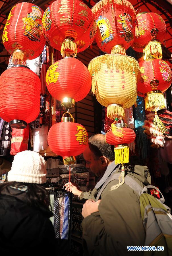 A customer chooses festival ornaments in a shop at China Town in New York, the United States, Jan. 20, 2012. Shopkeepers sold various ornaments in their shops at China Town for the approaching Spring Festival.