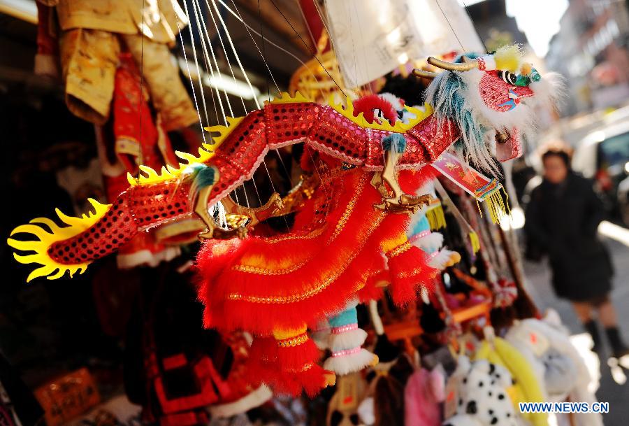An ornament of Chinese Dragon is seen outside a shop at China Town in New York, the United States, Jan. 20, 2012. Shopkeepers sold various ornaments in their shops at China Town for the approaching Spring Festival.