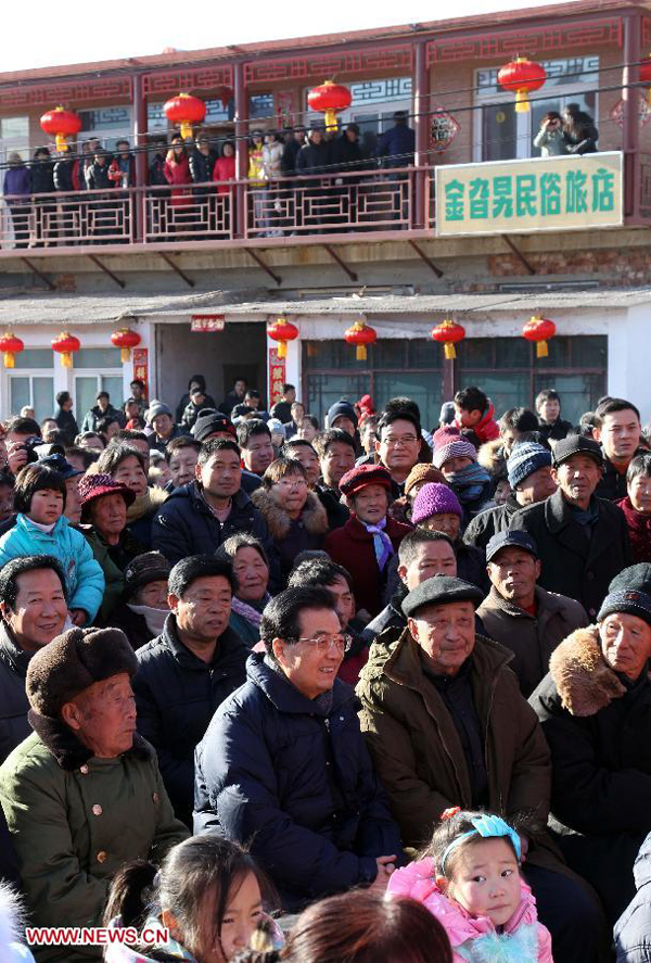 Chinese President Hu Jintao (2nd L 2nd row) watches 'Flower Is A Go-Between', a traditional opera, along with residents of Tianxianyu Village in the Huairou District of Beijing, capital of China, Jan. 22, 2012. Hu visited grassroots urban and rural areas in Beijing on Sunday, the eve of the Spring Festival, extending greetings to the people and celebrating with them the Chinese Lunar New Year.