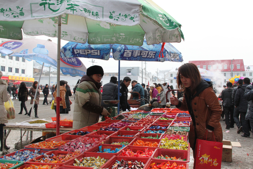 People do special purchases for the Spring Festival in a farmer's market in Lishi, Lvliang City, Shanxi Province. [China.org.cn, by Li Xiaohua]
