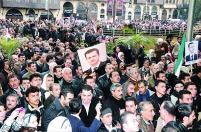 Syrian peoples attend a parade to support President Bashar al-Assad on Jan. 17. 