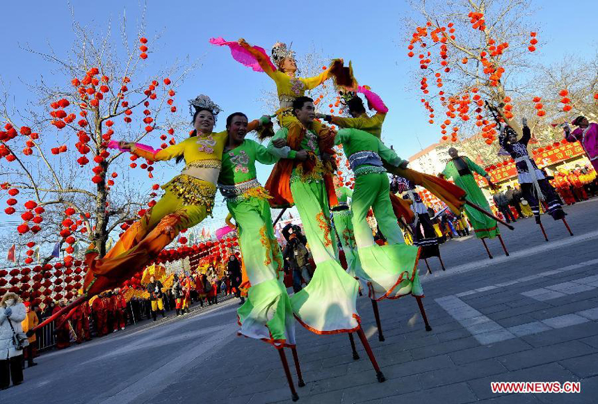 Acrobatic artists from Gaizhou, northeast China's Liaoning Province give stilt performance at the opening ceremony of the 29th Spring Festival Temple Fair at Longtan Park in Beijing, capital of China, Jan. 22, 2012. The 8-day event, opening here on Sunday, will provide visitors with an access to various folk dances and other festive entertainments.