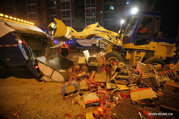 Sanitation workers clean the firecracker residue on a street in Beijing on Jan. 23, 2012. A good deal of firecrackers has been set off on the eve before Spring Festival as a kind of Chinese folk tradition.