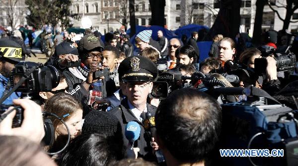 A Washington police officer speaks to media at McPherson Square in Washington D.C., Jan. 30, 2012. [Fang Zhe/Xinhua]