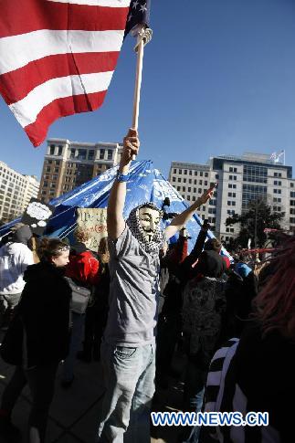 Occupy D.C. protesters shout slogans in front of the McPherson statue covered with a blue water-proof cloth at McPherson Square in Washington D.C., Jan. 30, 2012. [Fang Zhe/Xinhua]