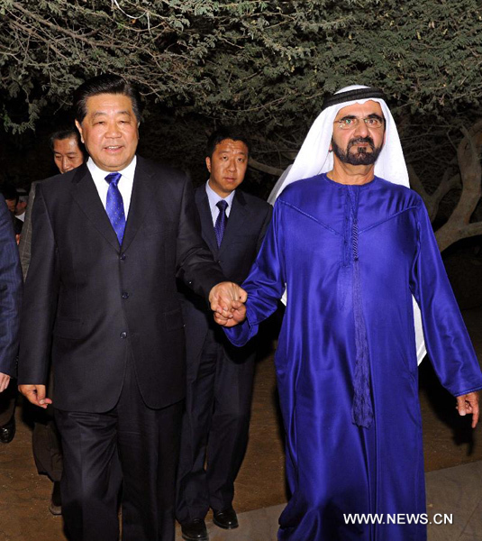 Jia Qinglin (L, front), chairman of the National Committee of the Chinese People's Political Consultative Conference, meets with Sheikh Mohammed bin Rashid Al-Maktoum (R), vice president and prime minister of the United Arab Emirates (UAE), who is also ruler of Dubai, in Dubai, the UAE, Jan. 30, 2012. [Rao Aimin/Xinhua] 