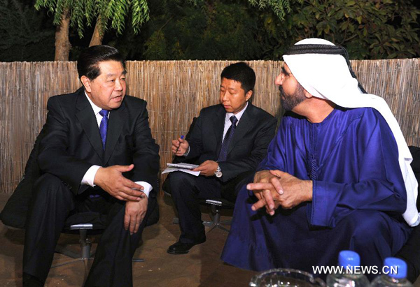 Jia Qinglin (L), chairman of the National Committee of the Chinese People's Political Consultative Conference, meets with Sheikh Mohammed bin Rashid Al-Maktoum (R), vice president and prime minister of the United Arab Emirates (UAE), who is also ruler of Dubai, in Dubai, the UAE, Jan. 30, 2012. [Rao Aimin/Xinhua]