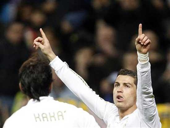 Real Madrid's Cristiano Ronaldo celebrates his goal against Real Zaragoza with teammate Kaka (L) during their Spanish first division soccer match at Santiago Bernabeu stadium in Madrid January 28, 2012.