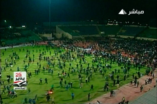 In this still image taken from video, soccer fans invade the pitch during a soccer match between Al Ahli and al-Masry in Port Said Feb 1, 2012. [Agencies] 