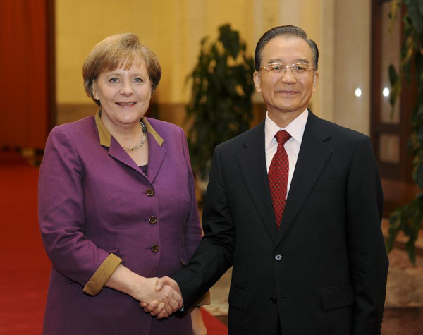 Chinese Premier Wen Jiabao (R) shakes hands with visiting German Chancellor Angela Merkel at the welcoming ceremony before their talks in Beijing, capital of China, Feb. 2, 2012. [Xie Huanchi/Xinhua]