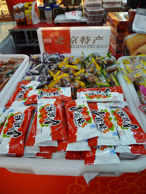 Local snacks are on display in an indoor temple fair in the Golden Resources Shopping Mall located in the northwest part of Beijing during the Spring Festival 2012, where visitors can enjoy the charm of the traditional Chinese arts and the delicacy of local snacks. [By Xu Lin / China.org.cn]