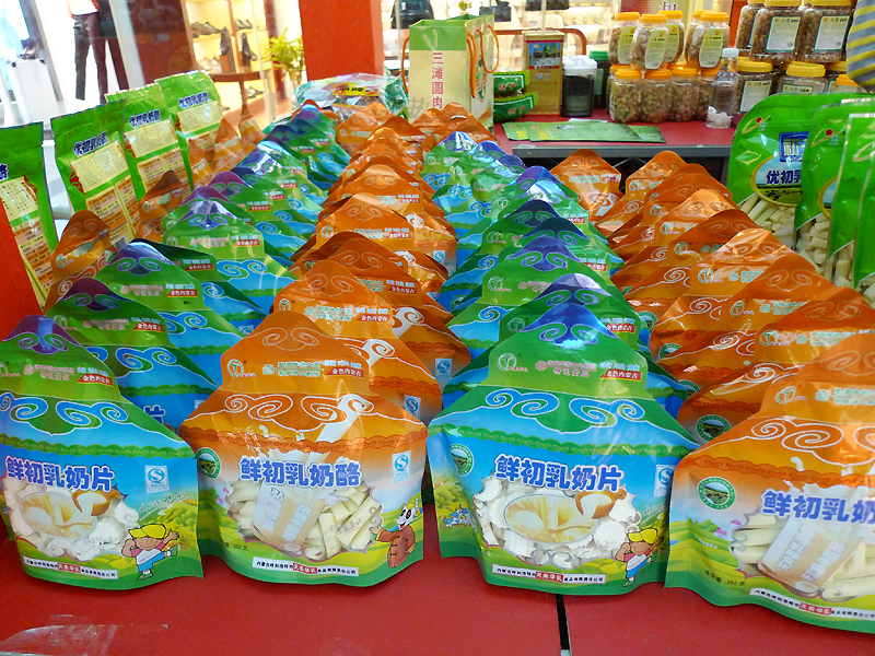 Local snacks are on display in an indoor temple fair in the Golden Resources Shopping Mall located in the northwest part of Beijing during the Spring Festival 2012, where visitors can enjoy the charm of the traditional Chinese arts and the delicacy of local snacks. [By Xu Lin / China.org.cn]