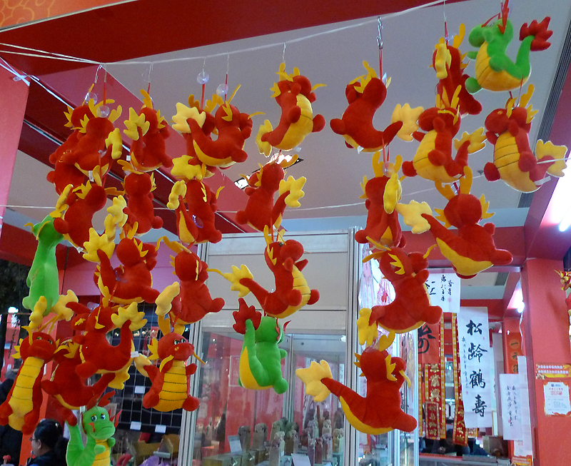 Dragon toys are on display in an indoor temple fair in the Golden Resources Shopping Mall located in the northwest part of Beijing during the Spring Festival 2012, to celebrate the year of dragon. Visitors can enjoy the charm of the traditional Chinese arts and the delicacy of local snacks in the fair. [By Xu Lin / China.org.cn]