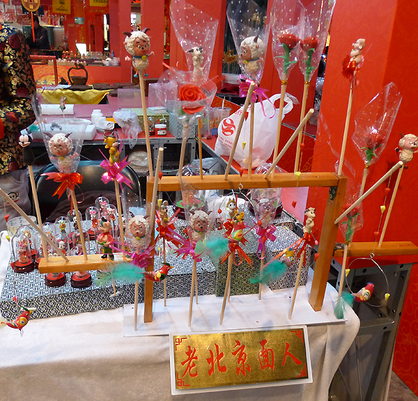 Dough figurines, a folk art of Beijing, are on display in an indoor temple fair in the Golden Resources Shopping Mall located in the northwest part of Beijing during the Spring Festival 2012, where visitors can enjoy the charm of the traditional Chinese arts and the delicacy of local snacks. [By Xu Lin / China.org.cn]