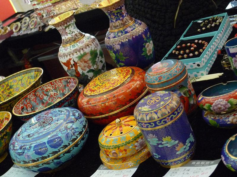 Cloisonne works, traditional enamel wares, are on display in an indoor temple fair in the Golden Resources Shopping Mall located in the northwest part of Beijing during the Spring Festival 2012, where visitors can enjoy the charm of the traditional Chinese arts and the delicacy of local snacks. [By Xu Lin / China.org.cn]