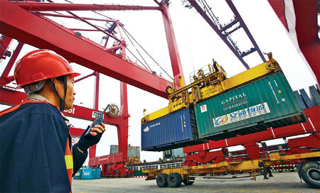 Containers being loaded at a dock in Haikou, capital city of Hainan province. IMF officials say some modest financial support for the Chinese economy is warranted in light of the risk of a global downturn.[China Daily]