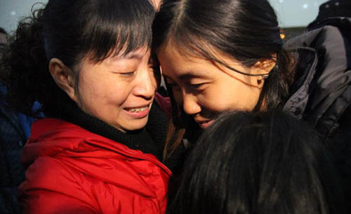 Xia Wenqiong (R), who was just rescued from abduction in Sudan, hugs her relatives in Pengshan County, southwest China's Sichuan Province, Feb. 9, 2012. A total of 47 Chinese were caught in the attack, which occurred in a southern Sudanese state 13 days ago. Twenty-nine of them were abducted by the assailants while the other 18 managed to flee.  [Xinhua] 