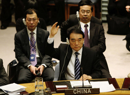 China's Ambassador Li Baodong (front) votes during a UN Security Council meeting on an Arab-European draft resolution on Syria backing an Arab League plan which demands a regime change in the Middle East country, New York February 4, 2012. [Photo/Xinhua] 