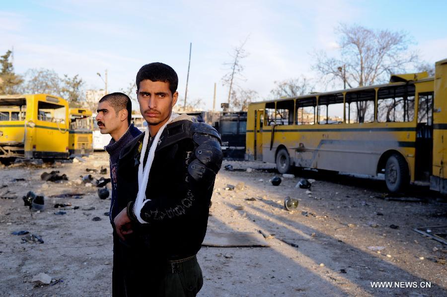 A policeman wounded looks around at the explosion site of a law-enforcement force in Hanano area in Aleppo, northern Syria, Feb. 10, 2012. Twin deadly blasts caused by car bombs hit two sites of Syrian government forces in northern Aleppo province Friday, leaving 28 people killed and other 235 injured, said Syria's official media, blaming the attacks on armed groups backed by foreign plot. 